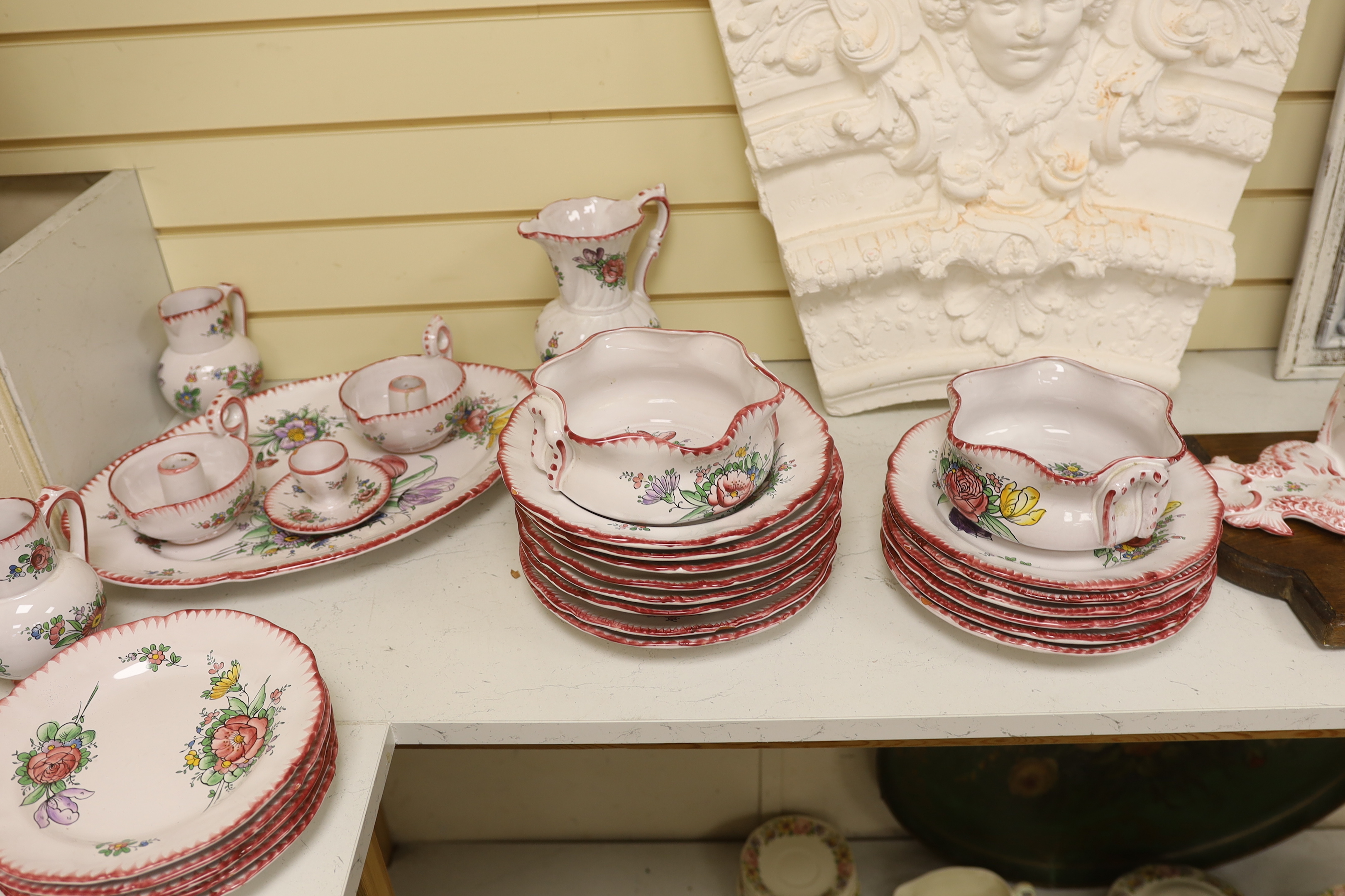 Le Renoleau Faiencerie D'Art, Angouleme, French faience tableware with floral decoration, including lidded serving pots, tureens, jugs, serving dishes, coasters, plates, candle stands, a candlestick, a water dispenser fo